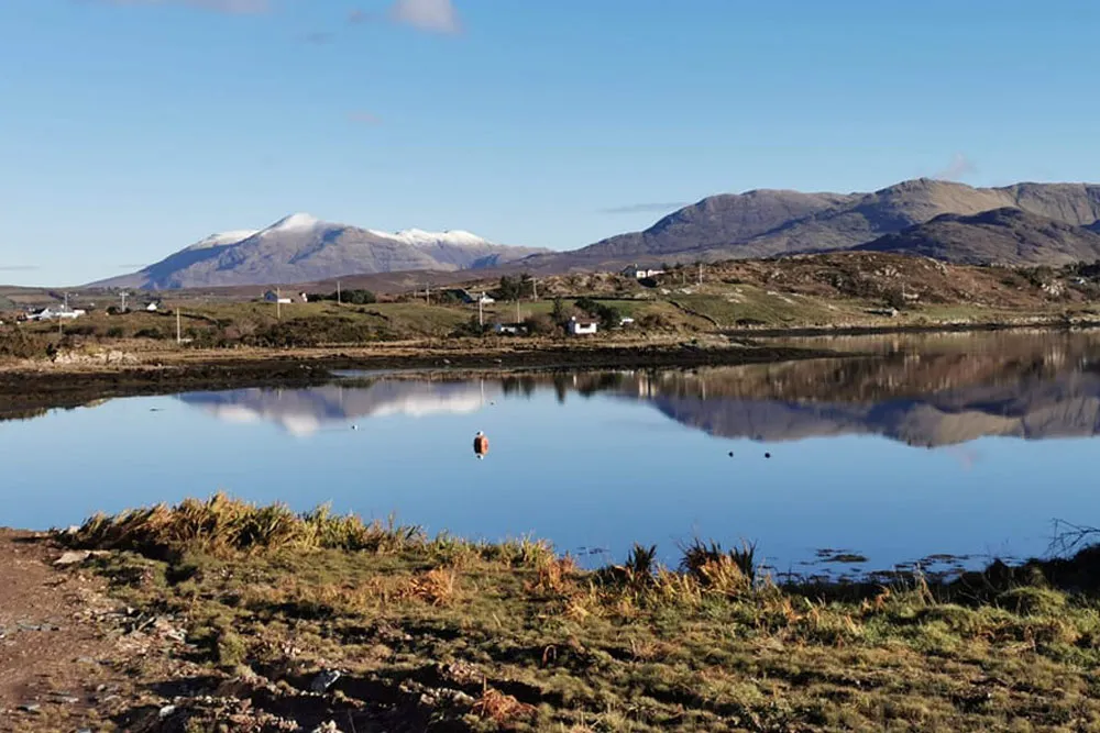 Ballinakill Bay landscape with the snow-capped Connemara Mountains. wp-image-1383