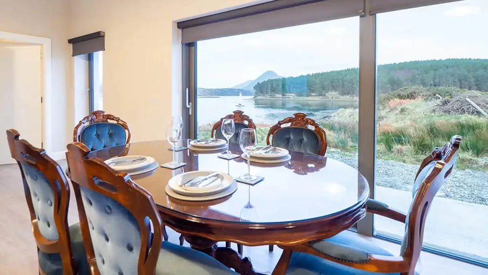 Classic style Oyster House dining table and chairs, beside large window view of bay and mountains wp-image-586
