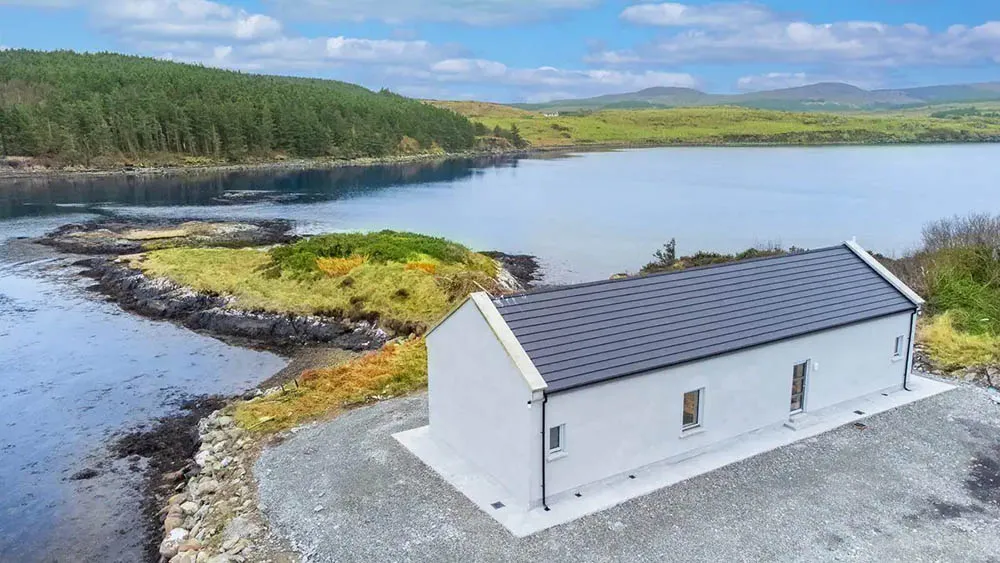Aerial view of Oyster House in Ballinakill Bay. Overlooking water, forest and mountains. wp-image-578