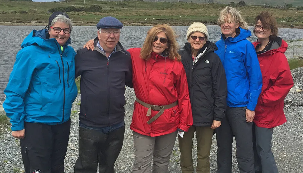 Oyster Tour group of five with David Keane, arm in arm on the shore of Ballinakill Bay, Connemara wp-image-798